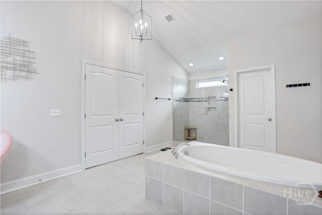 301 Highland Cir, Richmond Hill, GA 31324 - full bath with a bath, lofted ceiling, a chandelier, a tile shower, and baseboards