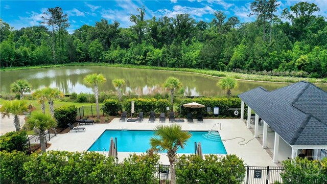 301 Highland Cir, Richmond Hill, GA 31324 - community pool featuring a water view, a patio, and a forest view