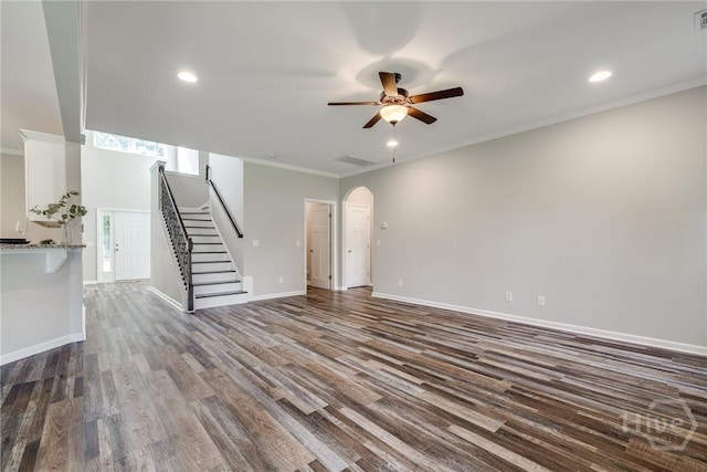 447 Nease Rd, Guyton, GA 31312 - unfurnished living room with ceiling fan, stairs, dark wood finished floors, arched walkways, and ornamental molding