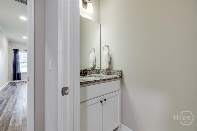 447 Nease Rd, Guyton, GA 31312 - bathroom with ornamental molding, vanity, wood finished floors, and baseboards
