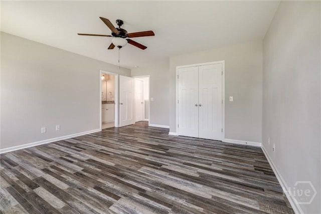 447 Nease Rd, Guyton, GA 31312 - unfurnished bedroom with dark wood-style flooring, a closet, baseboards, a ceiling fan, and connected bathroom