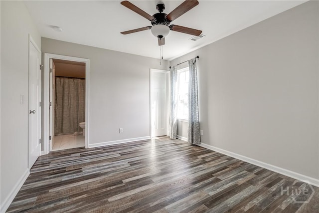 447 Nease Rd, Guyton, GA 31312 - unfurnished bedroom with baseboards, dark wood finished floors, ensuite bathroom, and a ceiling fan