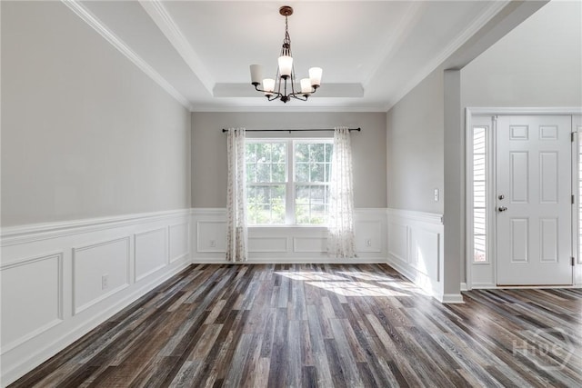 447 Nease Rd, Guyton, GA 31312 - unfurnished dining area with a chandelier, a raised ceiling, dark wood finished floors, wainscoting, and a decorative wall