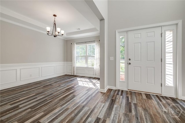 447 Nease Rd, Guyton, GA 31312 - entrance foyer with a chandelier, dark wood-style floors, a raised ceiling, and crown molding