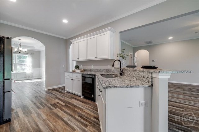 447 Nease Rd, Guyton, GA 31312 - kitchen featuring black appliances, a sink, dark wood finished floors, white cabinets, and arched walkways