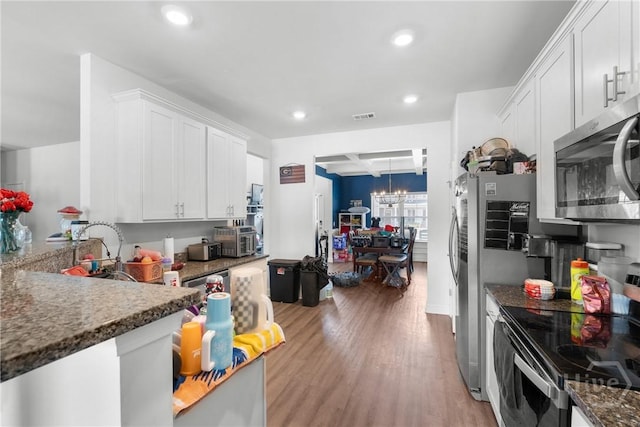 108 Franklins Walk, Rincon, GA 31326 - kitchen featuring appliances with stainless steel finishes, a chandelier, recessed lighting, light wood-type flooring, and white cabinetry