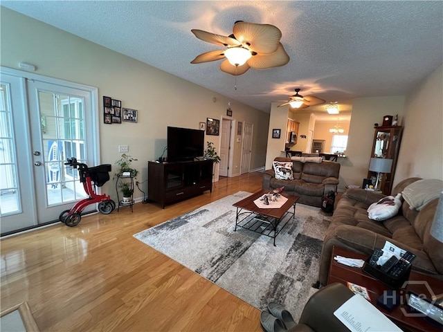 103 Travertine Cir, Savannah, GA 31419 - living room with wood finished floors, a textured ceiling, a chandelier, ceiling fan, and baseboards