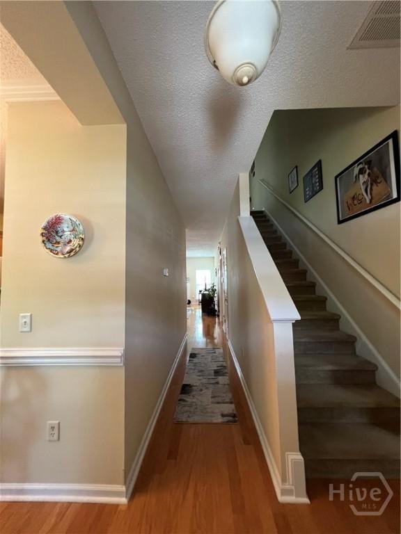 103 Travertine Cir, Savannah, GA 31419 - hall featuring wood finished floors, baseboards, stairway, and a textured ceiling