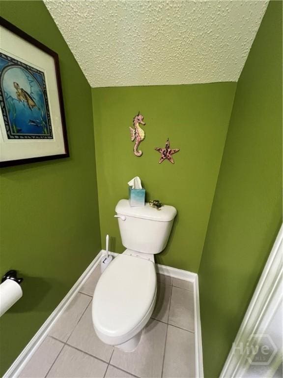 103 Travertine Cir, Savannah, GA 31419 - bathroom featuring tile patterned floors, a textured ceiling, baseboards, toilet, and lofted ceiling