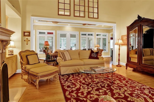 3 Gumtree Ln, Savannah, GA 31411 - living room with a high ceiling, light wood-style floors, crown molding, and baseboards