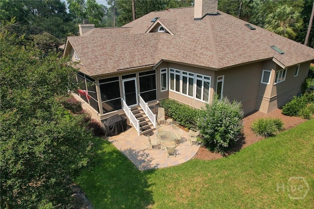 3 Gumtree Ln, Savannah, GA 31411 - rear view of house featuring a sunroom, roof with shingles, a chimney, a patio, and a yard