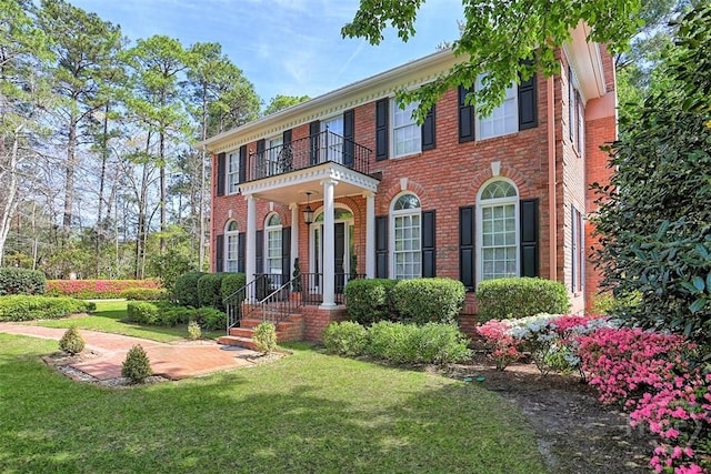 320 Wedgefield Xing, Savannah, GA 31405 - colonial house with brick siding, a balcony, and a front lawn