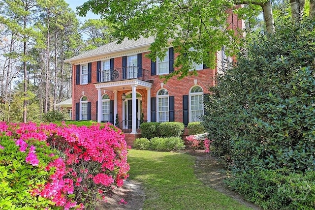 320 Wedgefield Xing, Savannah, GA 31405 - colonial house featuring brick siding, a balcony, and a front lawn