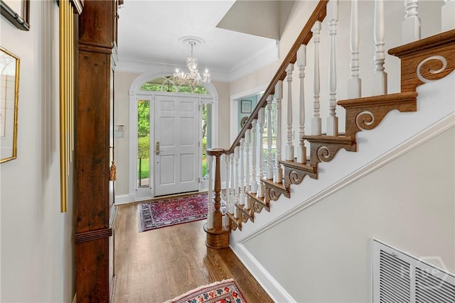 320 Wedgefield Xing, Savannah, GA 31405 - foyer entrance with wood finished floors, stairs, a chandelier, ornamental molding, and baseboards