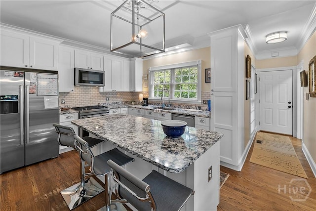 320 Wedgefield Xing, Savannah, GA 31405 - kitchen with high quality appliances, light stone counters, dark wood-style floors, and ornamental molding