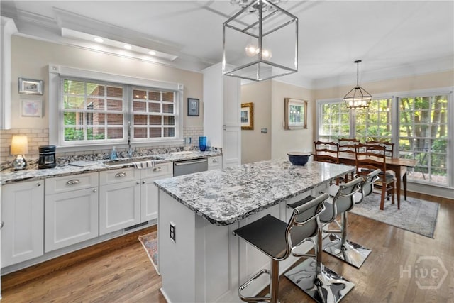 320 Wedgefield Xing, Savannah, GA 31405 - kitchen with a sink, a chandelier, wood finished floors, tasteful backsplash, and ornamental molding