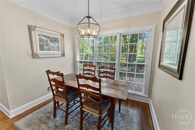 320 Wedgefield Xing, Savannah, GA 31405 - dining area featuring baseboards, wood finished floors, ornamental molding, and a chandelier