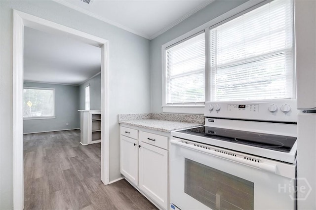 133 Parsons Ave, Pooler, GA 31322 - kitchen featuring white electric stove, crown molding, wood finished floors, white cabinets, and light stone countertops