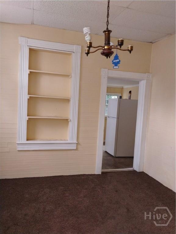501 W 42nd St W, Savannah, GA 31415 - carpeted empty room featuring a chandelier