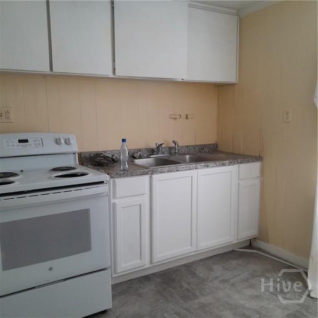 501 W 42nd St W, Savannah, GA 31415 - kitchen featuring white electric stove, a sink, white cabinetry, and dark countertops