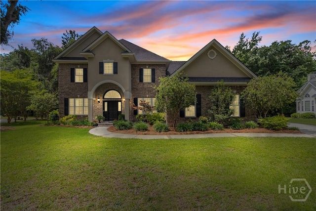 325 Shadow Moss Cir, Richmond Hill, GA 31324 - view of front of house with a front yard, brick siding, and stucco siding