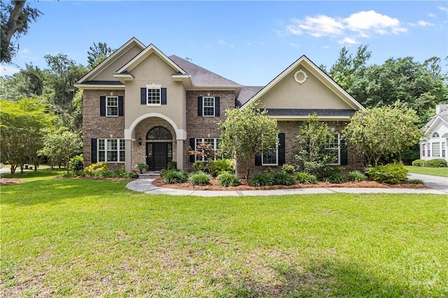 325 Shadow Moss Cir, Richmond Hill, GA 31324 - view of front of property featuring stucco siding, a front lawn, and brick siding