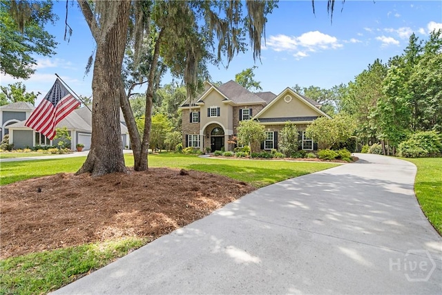 325 Shadow Moss Cir, Richmond Hill, GA 31324 - traditional home featuring stucco siding and a front yard