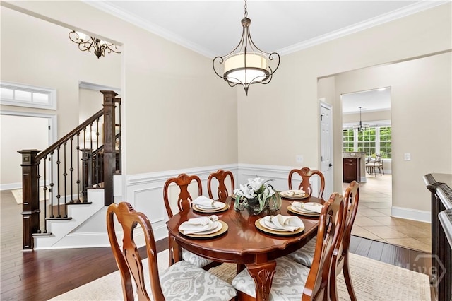 325 Shadow Moss Cir, Richmond Hill, GA 31324 - dining space with wood finished floors, ornamental molding, stairway, and a chandelier