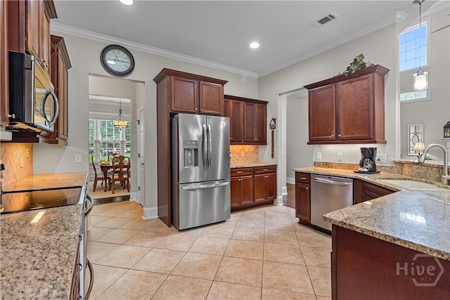 325 Shadow Moss Cir, Richmond Hill, GA 31324 - kitchen with appliances with stainless steel finishes, decorative backsplash, light tile patterned floors, light stone countertops, and crown molding
