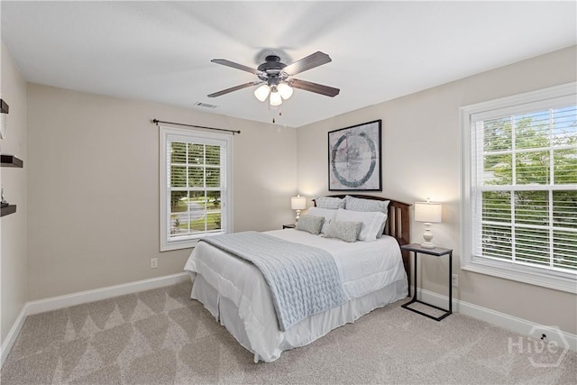 325 Shadow Moss Cir, Richmond Hill, GA 31324 - bedroom featuring multiple windows, light colored carpet, and a ceiling fan