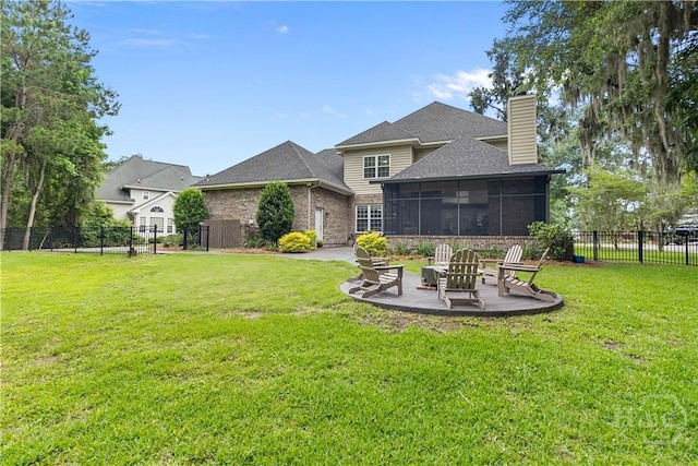 325 Shadow Moss Cir, Richmond Hill, GA 31324 - rear view of house with a patio, a chimney, a sunroom, roof with shingles, and brick siding