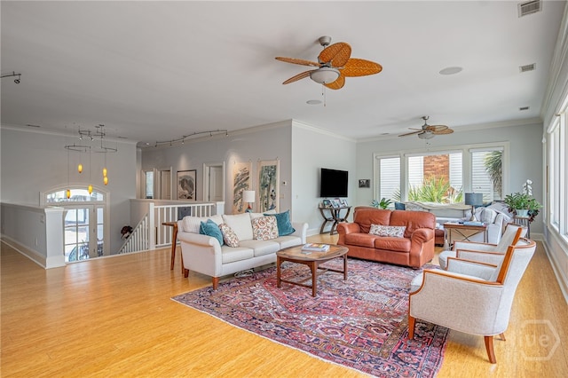 27 Mainsail Xing, Savannah, GA 31411 - living area featuring wood finished floors, a ceiling fan, crown molding, rail lighting, and baseboards