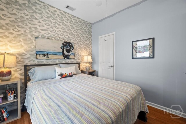 130 Lewis Ave, Tybee Island, GA 31328 - bedroom with baseboards, wood finished floors, and wallpapered walls
