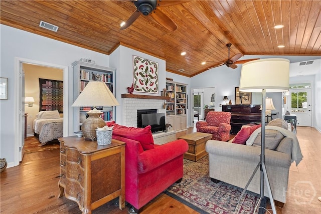 130 Lewis Ave, Tybee Island, GA 31328 - living area with a ceiling fan, wood ceiling, wood finished floors, a brick fireplace, and lofted ceiling