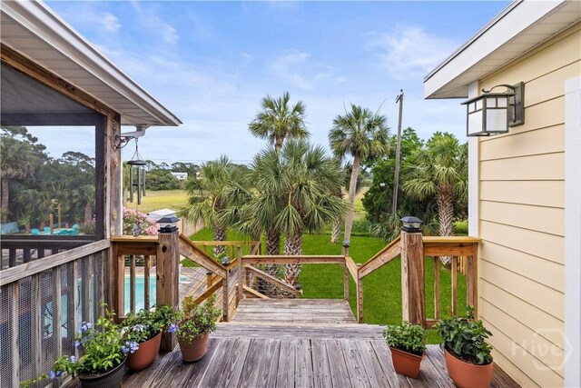 130 Lewis Ave, Tybee Island, GA 31328 - wooden terrace featuring a lawn and an outdoor pool