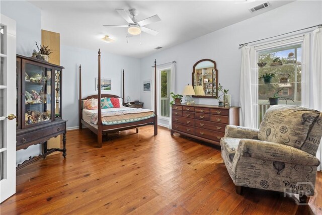 130 Lewis Ave, Tybee Island, GA 31328 - bedroom with access to exterior, multiple windows, wood finished floors, and a ceiling fan