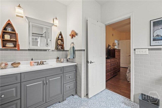 130 Lewis Ave, Tybee Island, GA 31328 - bathroom featuring tile walls, vanity, and wainscoting