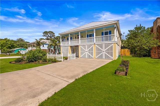 130 Lewis Ave, Tybee Island, GA 31328 - raised beach house with driveway and a balcony