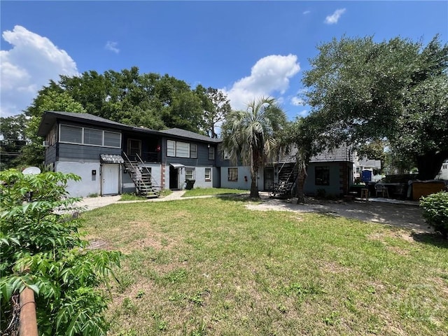 28 W 61st St, Savannah, GA 31405 - rear view of property with stairs and a yard