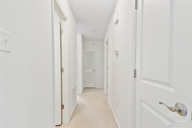 4715 Oakview Dr, Savannah, GA 31405 - corridor with a textured ceiling, light carpet, and baseboards