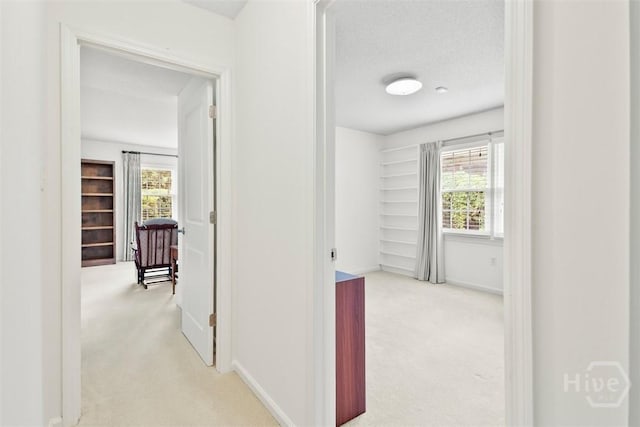 4715 Oakview Dr, Savannah, GA 31405 - hallway featuring carpet floors, baseboards, and a textured ceiling