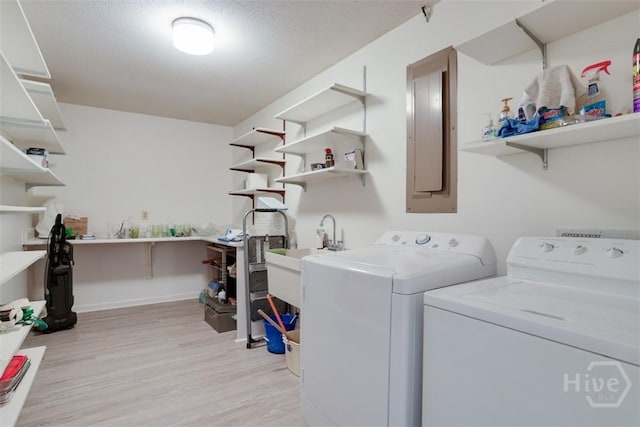 4715 Oakview Dr, Savannah, GA 31405 - laundry area featuring washing machine and clothes dryer, electric panel, and light wood-style flooring