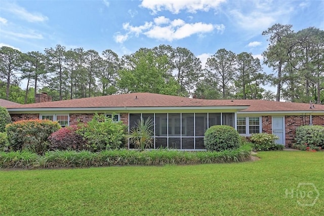 4715 Oakview Dr, Savannah, GA 31405 - rear view of property with a sunroom, a yard, brick siding, and a chimney