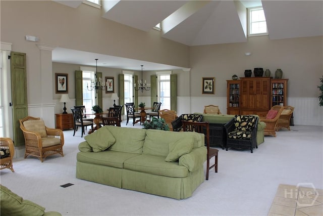 153 Como Dr, Pooler, GA 31322 - carpeted living area with high vaulted ceiling, a chandelier, wainscoting, and decorative columns