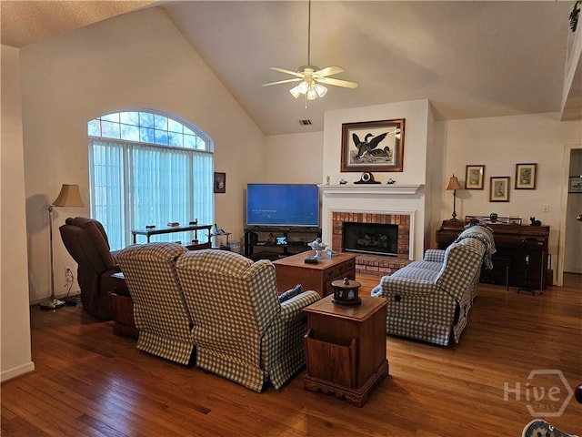 127 Lakeshore Dr, Savannah, GA 31419 - living room featuring wood-type flooring, ceiling fan, vaulted ceiling, and a brick fireplace
