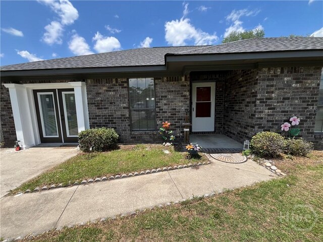 43 Fabian Ln, Hinesville, GA 31313 - property entrance featuring brick siding and roof with shingles