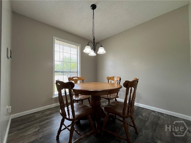 43 Fabian Ln, Hinesville, GA 31313 - dining space featuring a chandelier, a textured ceiling, dark wood-style floors, and baseboards