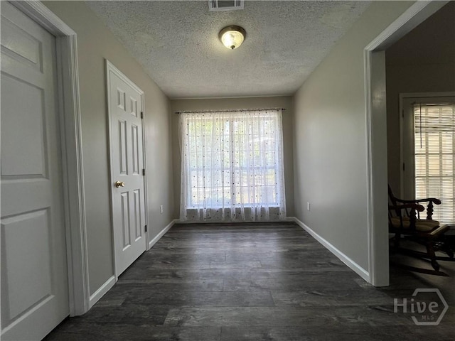 43 Fabian Ln, Hinesville, GA 31313 - unfurnished dining area with a textured ceiling, baseboards, and dark wood-style flooring