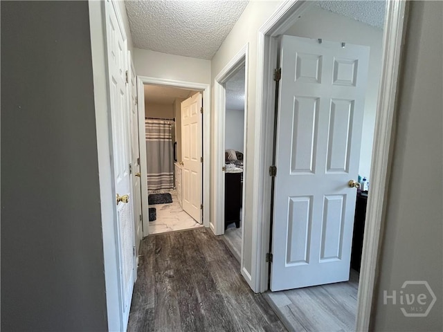 43 Fabian Ln, Hinesville, GA 31313 - hallway featuring a textured ceiling and dark wood-type flooring