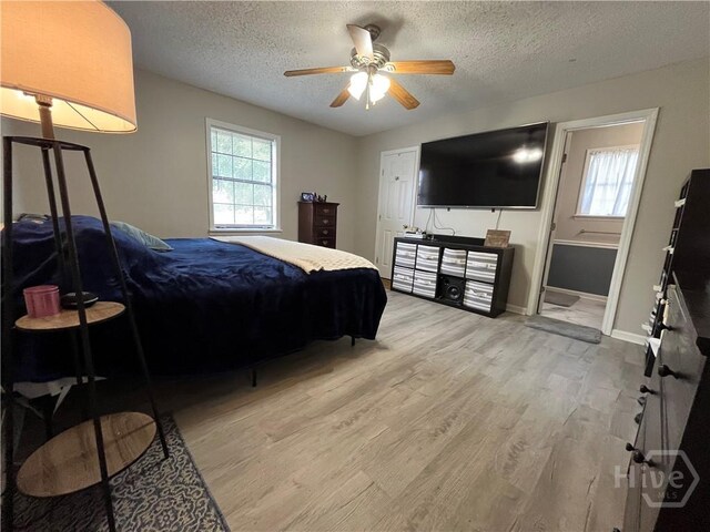 43 Fabian Ln, Hinesville, GA 31313 - bedroom featuring multiple windows, wood finished floors, a textured ceiling, baseboards, and ceiling fan
